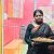 Sandhya stands outside her beauty parlour
