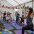 children wearing HOPE t-shirts take part in a Yoga Garden Party class for HOPE