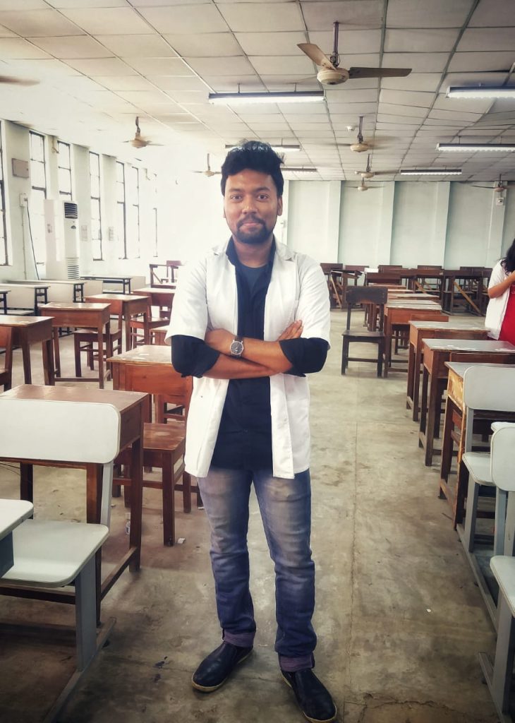 Jotish (name changed) wearing a white doctor's coat