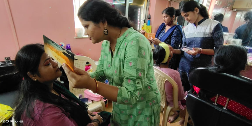 course participants learning how to apply make up
